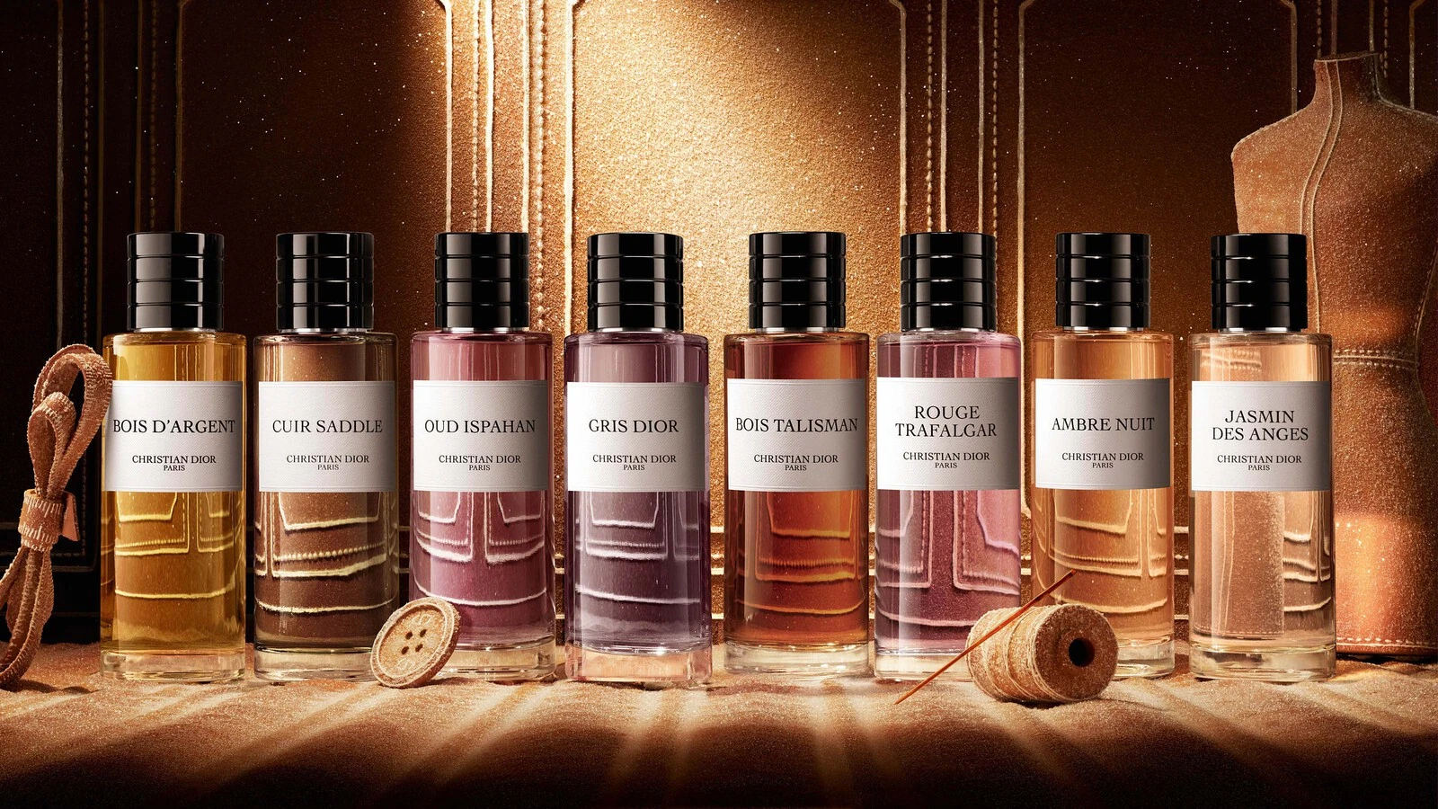 Dior La Collection Privée fragrance bottles photographed together in a gold setting