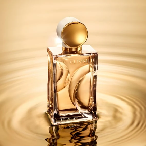 Estée Lauder Glimmer fragrance bottle photographed in golden light