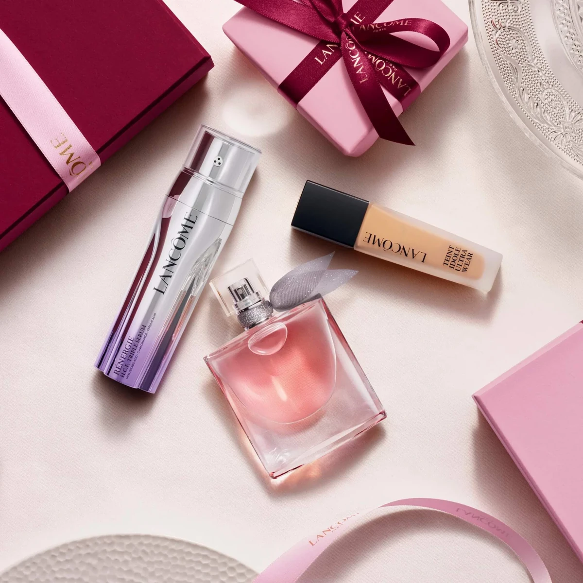 Lancôme perfume, mascara and foundation photographed with gift boxes and ribbon