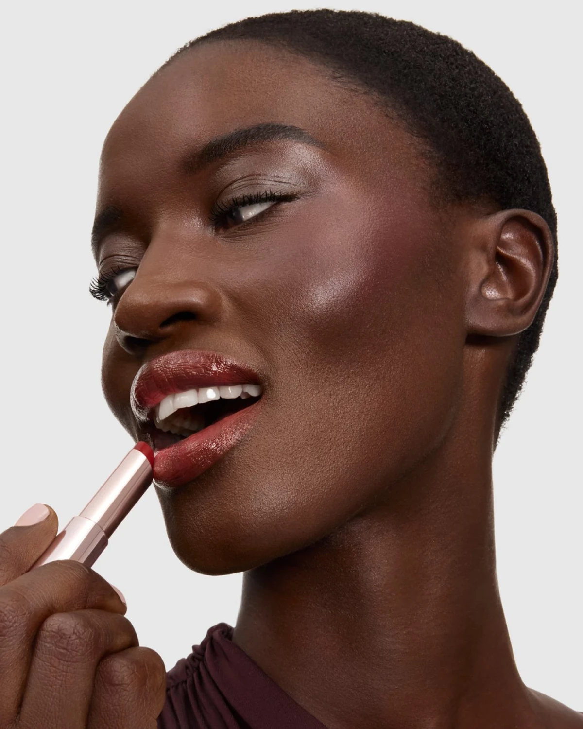 Lancôme beauty model applying a lip product in a real brand campaign photograph